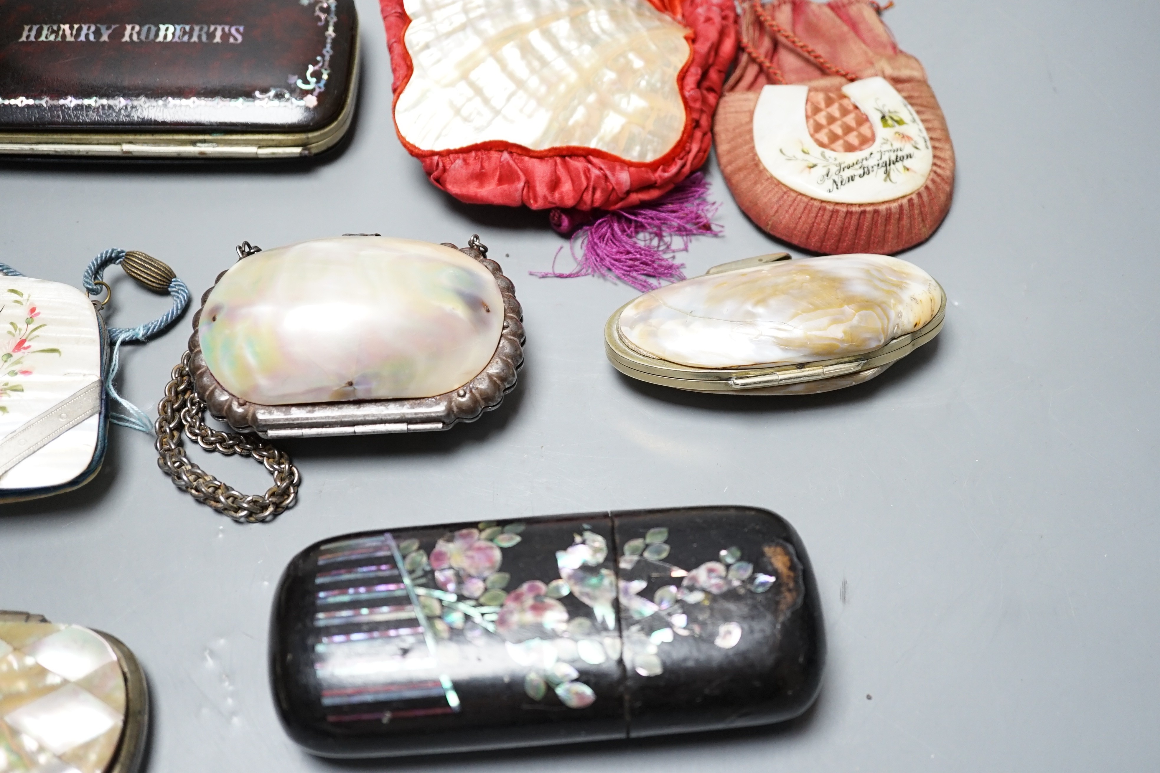 A collection of six mother of pearl souvenir purses, possibly from a grand tour and a papier-mâché mache card case and glasses case, card case 14 cms wide